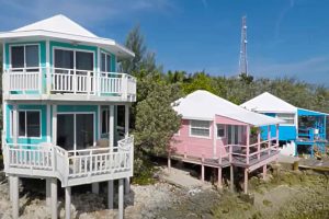 A group of colorful cottages on a Staniel Cay beach in The Bahamas.