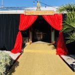 The entrance to Staniel Cay Yacht Club with red curtains and a red carpet.