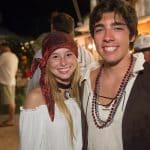A man and woman dressed as pirates pose for a photo at Staniel Cay Yacht Club in The Bahamas.