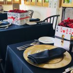 A black table setting adorned with red roses at the Staniel Cay Yacht Club.