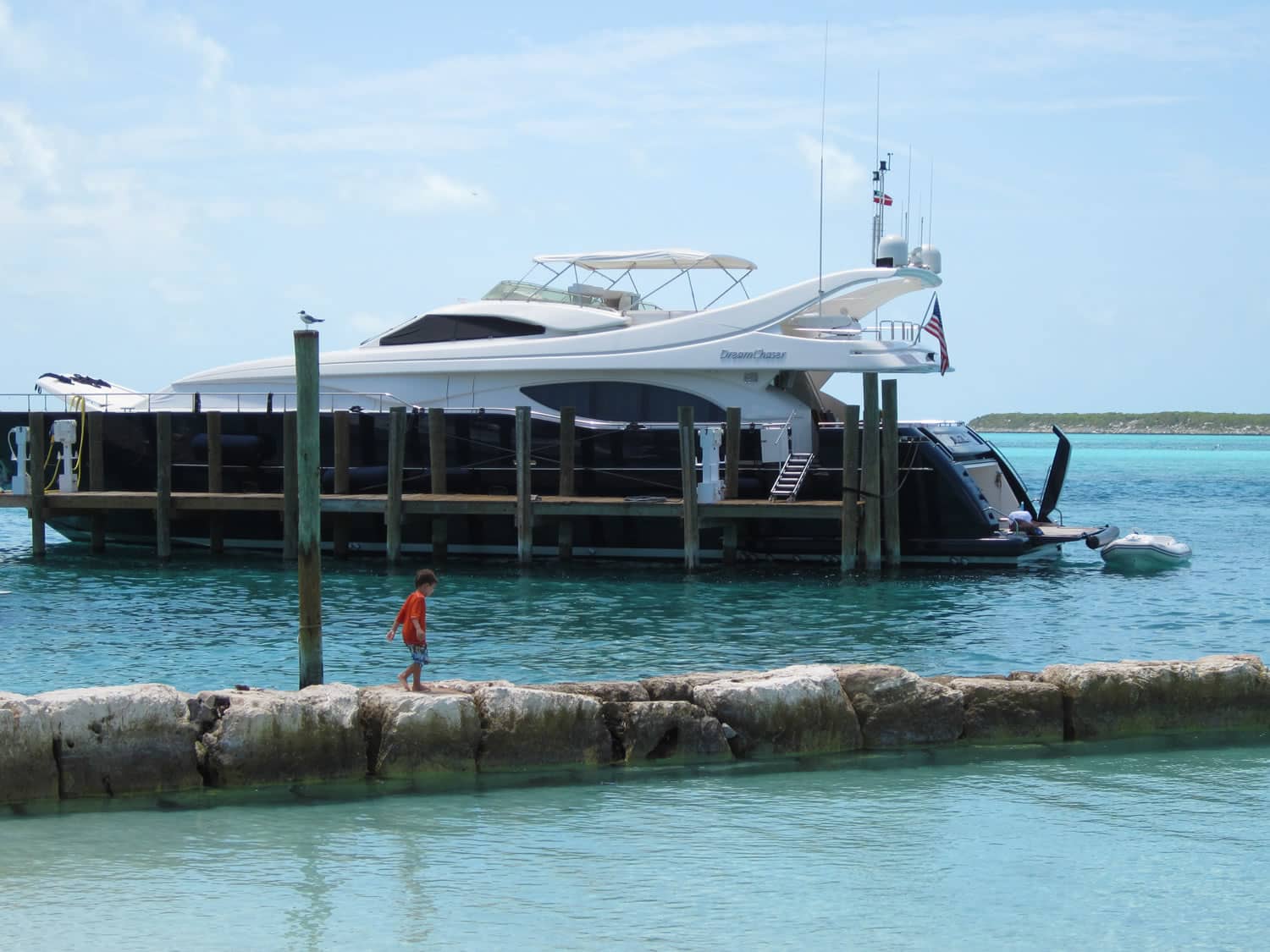 A boat docked in the turquoise waters of Staniel Cay in The Bahamas.