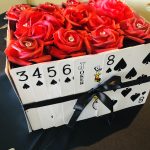 A box of roses with playing cards in it, perfect for Staniel Cay vacation rentals.