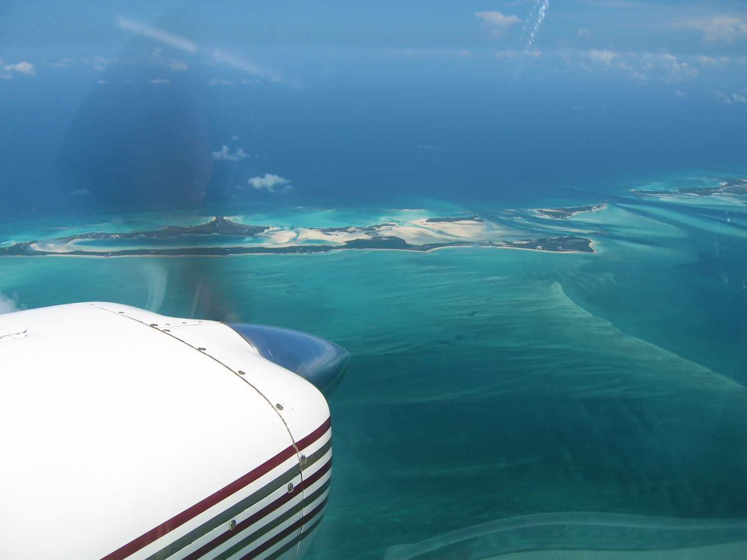 A breathtaking view of the ocean from a plane on a vacation to Staniel Cay in The Bahamas, near the renowned Staniel Cay Yacht Club.