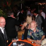 A group of men at a poker table at an event held at Staniel Cay Yacht Club.