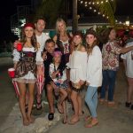 A group of people at Staniel Cay Yacht Club posing for a photo at a party.