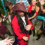 A group of people dressed as pirates are dancing at the Staniel Cay Yacht Club in The Bahamas.