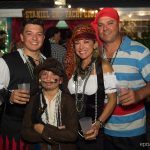 A group of people dressed as pirates pose for a photo at Staniel Cay Yacht Club in The Bahamas.