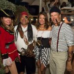 A group of people dressed as pirates pose for a photo during their vacation in The Bahamas.