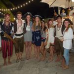 A group of people dressed as pirates posing for a photo at Staniel Cay Yacht Club.