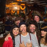 A group of people in pirate costumes posing for a photo during their vacation in Staniel Cay, The Bahamas.