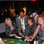 A group of people playing a game of croupier at Staniel Cay Yacht Club during their Staniel Cay Vacation Rentals.