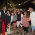 A group of people posing for a photo at Staniel Cay, a pirate party.