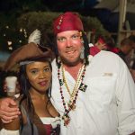 A man and woman dressed as pirates pose for a photo at Staniel Cay in The Bahamas.