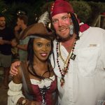 A man and woman dressed as pirates pose for a photo while enjoying their vacation at Staniel Cay.