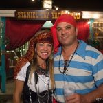 A man and woman dressed in pirate costumes pose for a photo at Staniel Cay Yacht Club in The Bahamas.