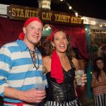 A man and woman dressed in pirate costumes pose for a photo during their vacation at Staniel Cay Yacht Club in The Bahamas.