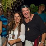 A man and woman posing for a picture at a Staniel Cay Yacht Club party.