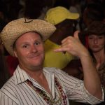 A man wearing a straw hat at a party in Staniel Cay, The Bahamas.