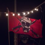 A red flag with a skull and crossbones on it, commonly seen in Staniel Cay, The Bahamas.