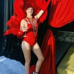 A woman in a Staniel Cay Vacation Rentals costume posing in front of a curtain.