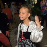 A young girl in a pirate costume waving to the crowd at Staniel Cay Yacht Club in The Bahamas.