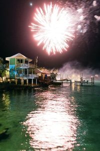Description: A firework explodes over a Staniel Cay vacation rental house on the water.