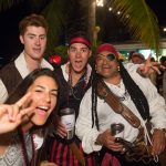 In The Bahamas, a group of people at Staniel Cay Yacht Club donning pirate costumes poses for a photo.