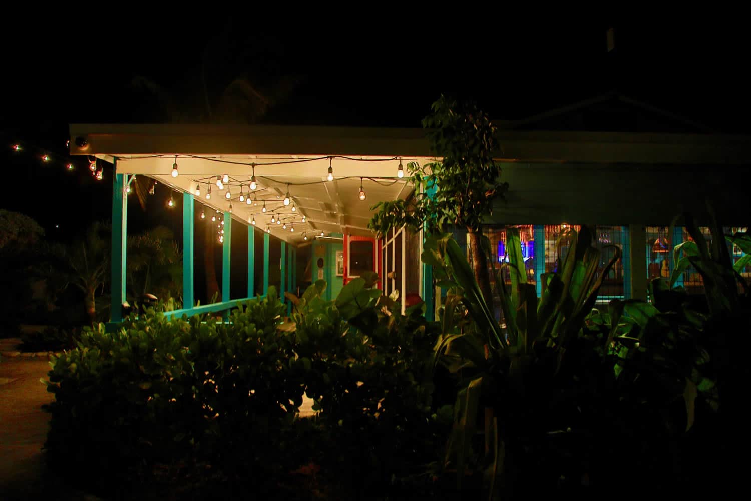 The Staniel Cay Yacht Club, a restaurant at night with string lights.