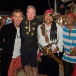 Three men in pirate costumes at Staniel Cay Yacht Club posing for a photo.
