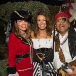 Three people dressed as pirates posing for a photo at Staniel Cay in The Bahamas.