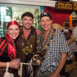 Three people dressed in pirate costumes pose for a photo at Staniel Cay in The Bahamas.