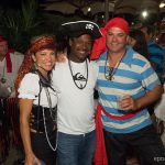 Three people posing for a photo at a party in Staniel Cay.