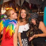 Three women dressed as pirates pose for a photo during their vacation in Staniel Cay, The Bahamas.