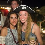 Two girls in pirate hats posing for a photo at a Staniel Cay party.