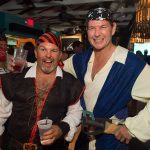 Two men dressed as pirates pose for a photo at Staniel Cay in The Bahamas.