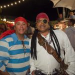 Two men in pirate costumes posing for a photo during their vacation at Staniel Cay Yacht Club.