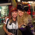 Two women in pirate costumes posing for a photo at Staniel Cay Yacht Club, The Bahamas.